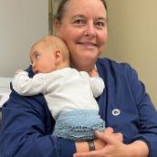 Photo of Shirley Mack with a newborn baby.