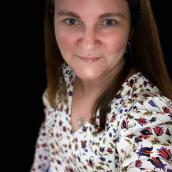 Photo of Jessica Wournell, Registered Nurse, and Provincial Clinical Nurse Lead of Nova Scotia Health’s Eating Disorder Provincial Service. She is smiling and taking a selfie; she is wearing a floral print long-sleeve shirt.