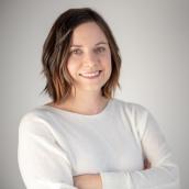 Woman with shoulder-length hair is smiling at the camera.