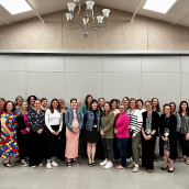 A group of about 25 people stand together in a large room, smiling at the camera. They are dressed in a mix of professional and casual clothing, with some wearing Nova Scotia Health badges. The group represents Aberdeen Hospital leaders who took part in the new safety education pilot.