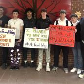 A group of boys stand together indoors, capturing a sense of camaraderie among the group.
