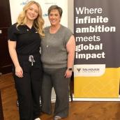 Two women are standing next to each other, both smiling. They are indoors in a setting related to Dalhousie University and Nova Scotia Health.
