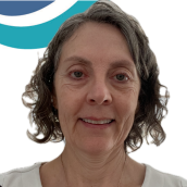 Close up picture of a woman with grey short, curly hair. 