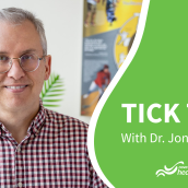 Man wearing a checkered red and white shirt wears glasses and is smiling at the camera next to a green block with a graphic of a tick and the title Tick Talk