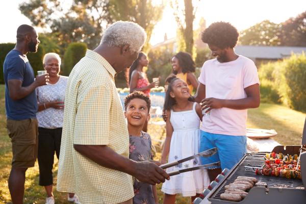Family barbecuing together laughing