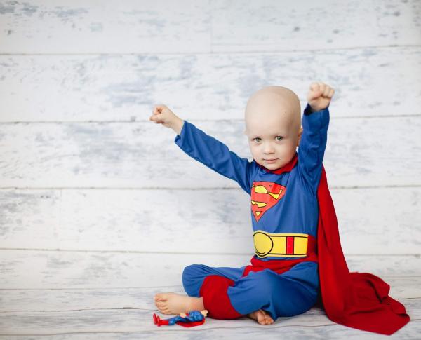 A little boy dressed as a superhero.