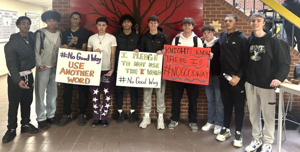 A group of boys stand together indoors, capturing a sense of camaraderie among the group.