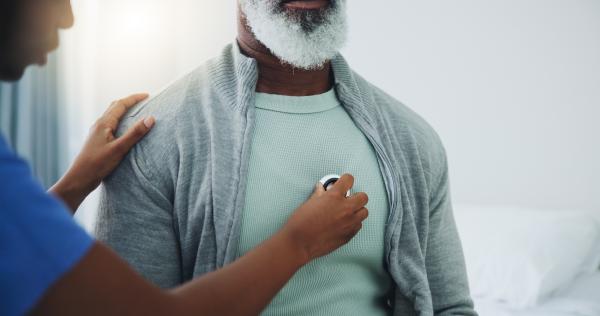 Doctor listens to man's lungs.jpeg