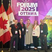 Photo of two men and three women at a conference in Ottawa