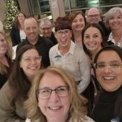 A group of smiling faces looking at the camera
