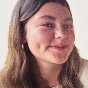 A head-and-shoulder image of a smiling woman.