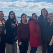 A group of people stand together outdoors.