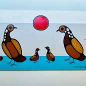 A photo of Indigenous artwork of five birds hangs in a hospital hallway. 