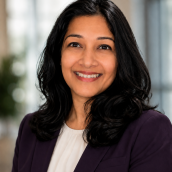 Professional headshot of Dr. Muna Chowdhury. Dr. Chowdhury is a woman with long dark hair, a white shirt and black blazer.