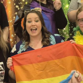 Three Youth Health Centre coordinators holding Pride flag