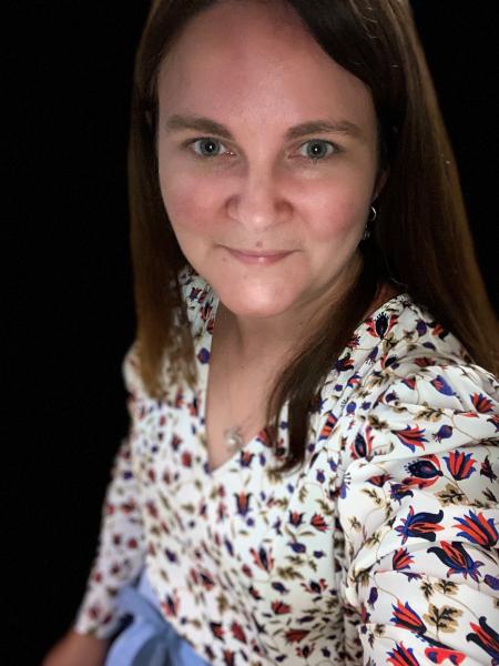 Photo of Jessica Wournell, Registered Nurse, and Provincial Clinical Nurse Lead of Nova Scotia Health’s Eating Disorder Provincial Service. She is smiling and taking a selfie; she is wearing a floral print long-sleeve shirt.