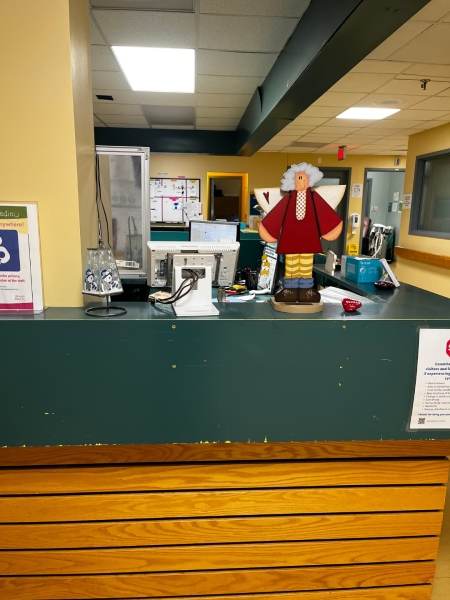 Nursing unit decorated for the holidays, a wooden angel and snowman candle holder sit on the counter.