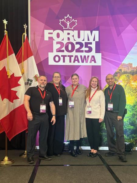 Photo of two men and three women at a conference in Ottawa