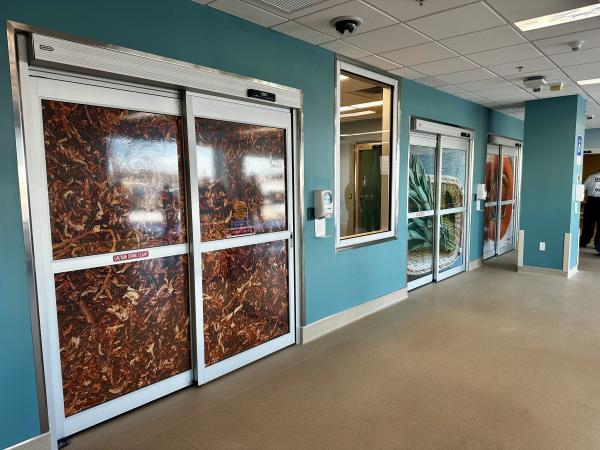 The newly renovated emergency department shows a series of sliding doors wrapped with artwork representing the four sacred medicines: tobacco, cedar, sage, and sweetgrass. 