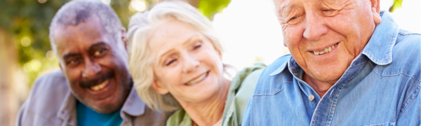 3 people, a woman in the middle of two men smiling.