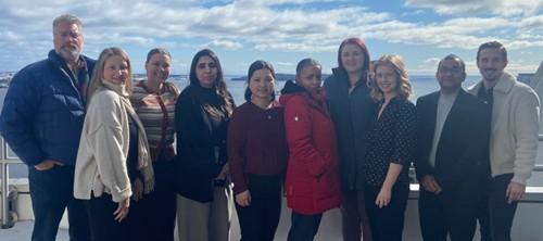 A group of people stand together outdoors.