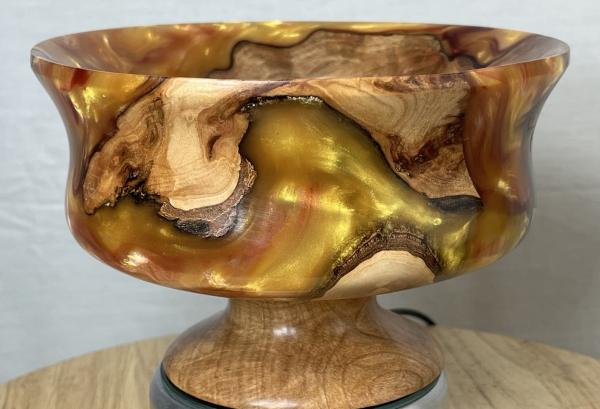 A bowl made of metal and wood.