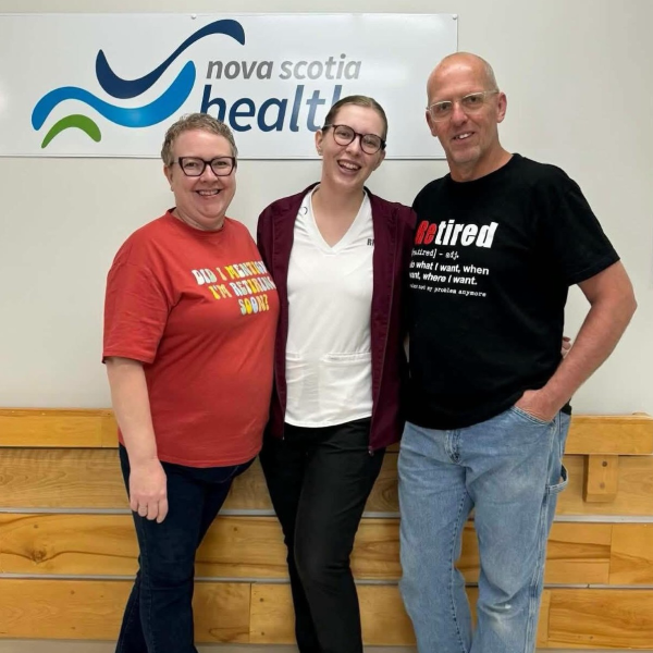 two women and one man standing
