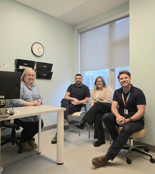 A group of healthcare professionals gathered around a desk.