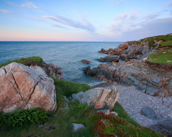 Beautiful scenic image of water and a rocky shoreline.
